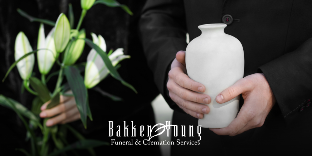 Simple memorial table with an urn, flowers, and framed photo in a calm setting